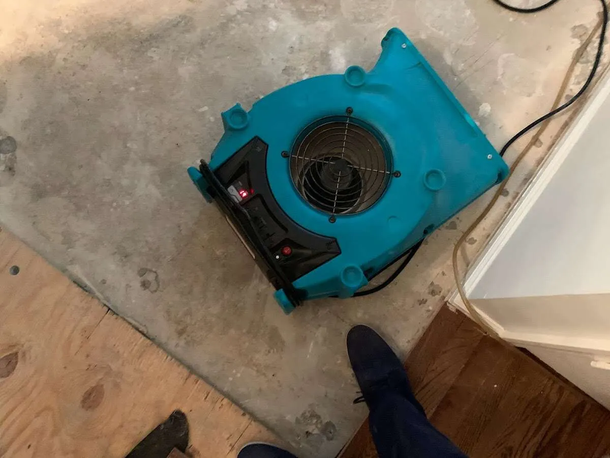 Air mover drying subfloor during Commercial Water Damage Restoration in Riverside